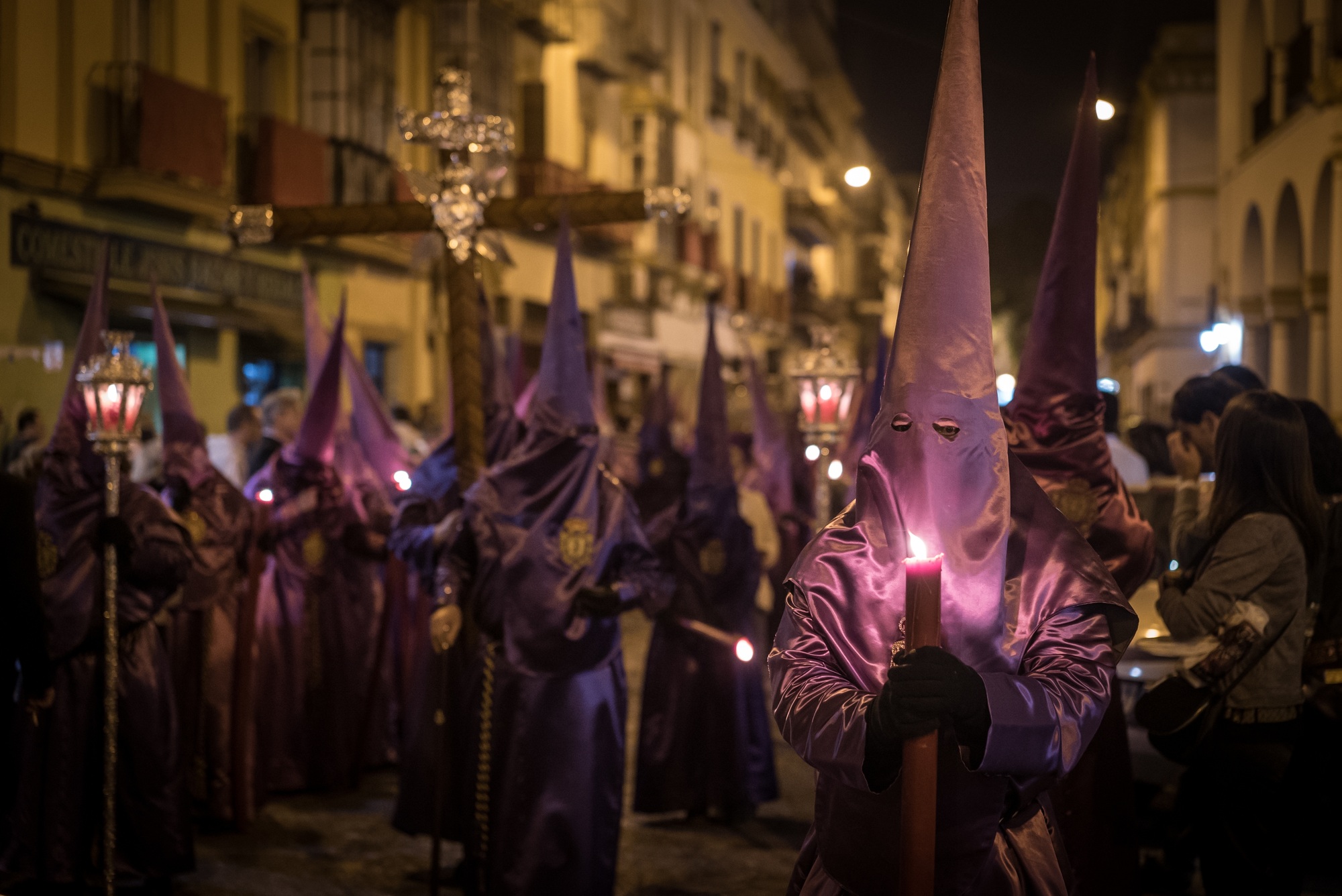 Crowd in costumes in Semana Santa Festival captured in Seville, Spain