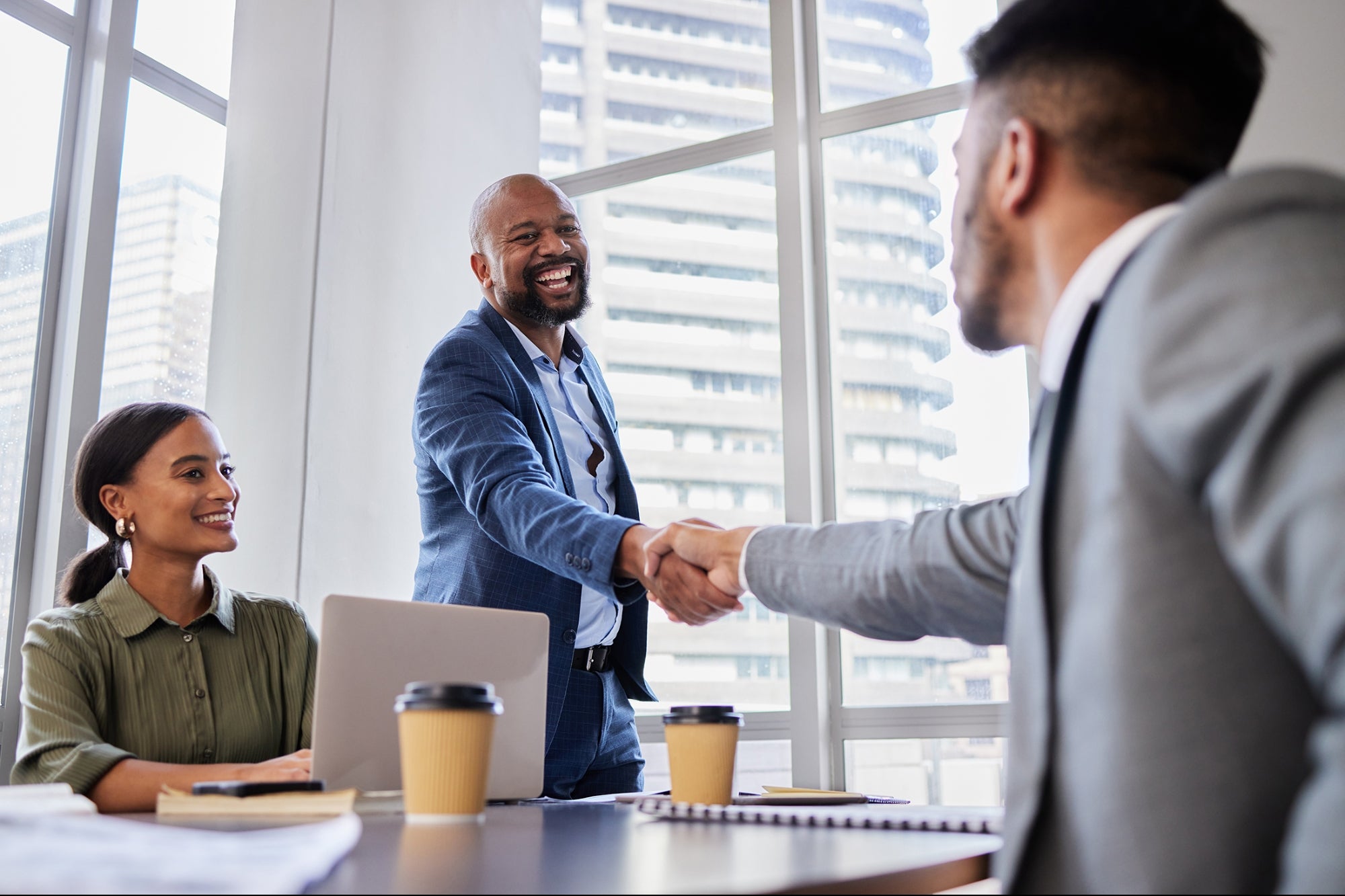 people shaking hands and closing a business
